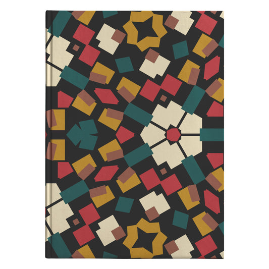 Hardcover journal with an Afro-Floral Fusion design featuring a kaleidoscopic array of geometric shapes and a central floral motif in a warm palette of red, yellow, green, and beige against a black background.