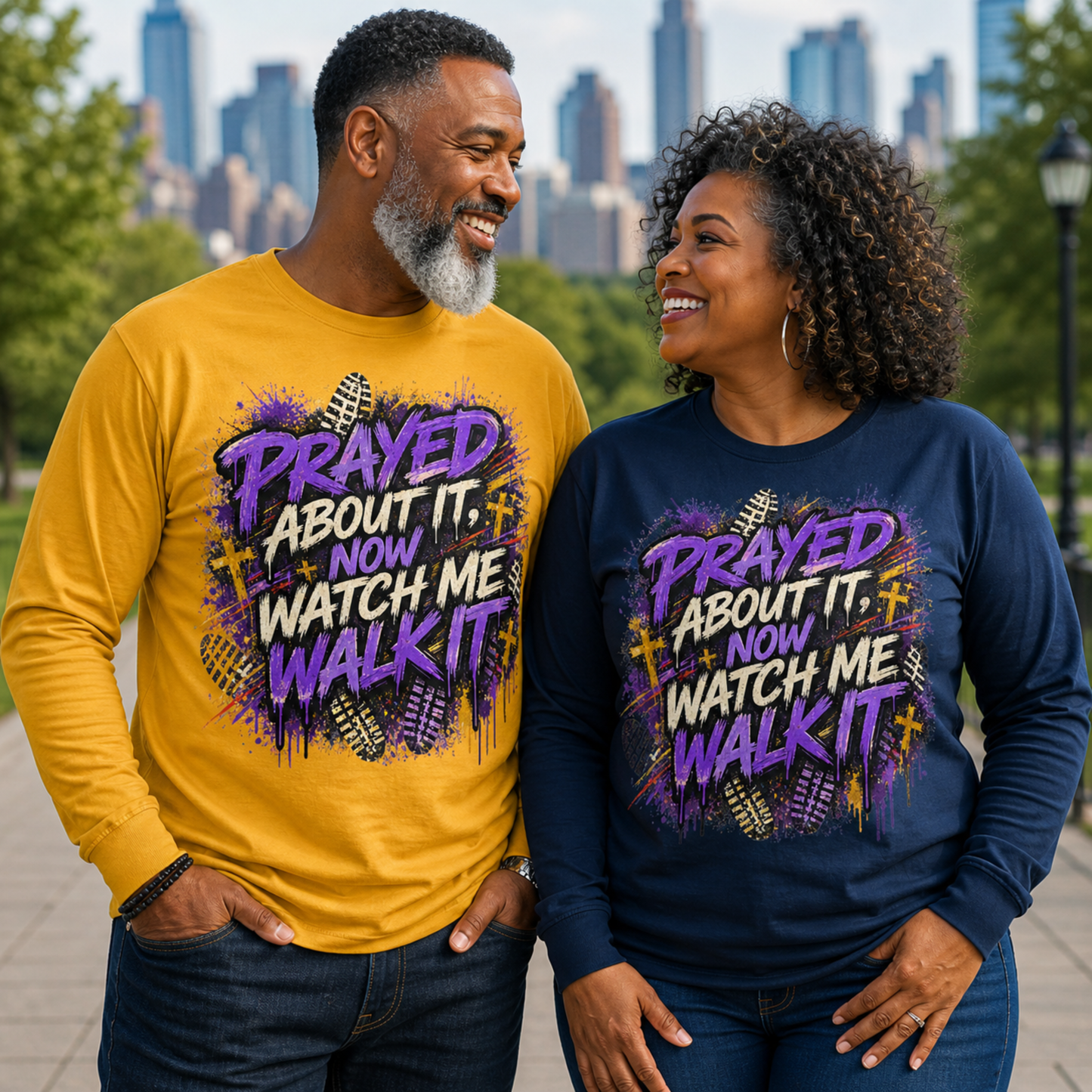 Two people wearing matching shirts with a motivational quote in an urban setting.