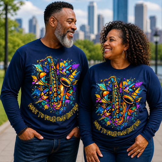 Two people wearing matching blue sweatshirts with colorful saxophone designs in an urban park setting.